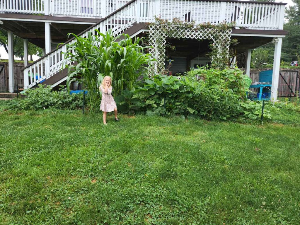 kid in front of garden