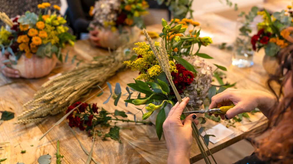 hands making a small herbal bouquet
